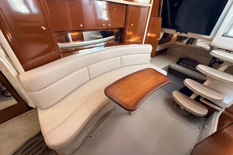 Slide: The Image of Luxurious interior of 2008 Sea Ray 340 Sundancer with elegant seating and wooden table. - 24