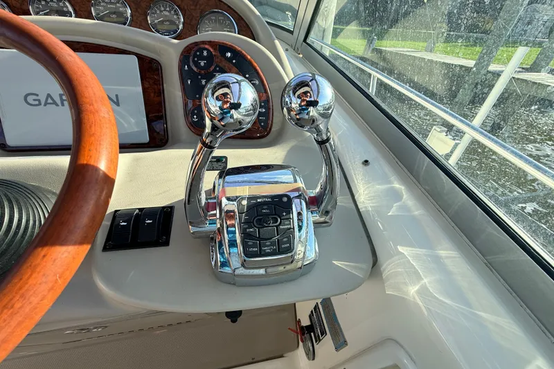 Slide: The Image of Control panel of a 2008 Sea Ray 340 Sundancer boat with wooden steering wheel. - 14