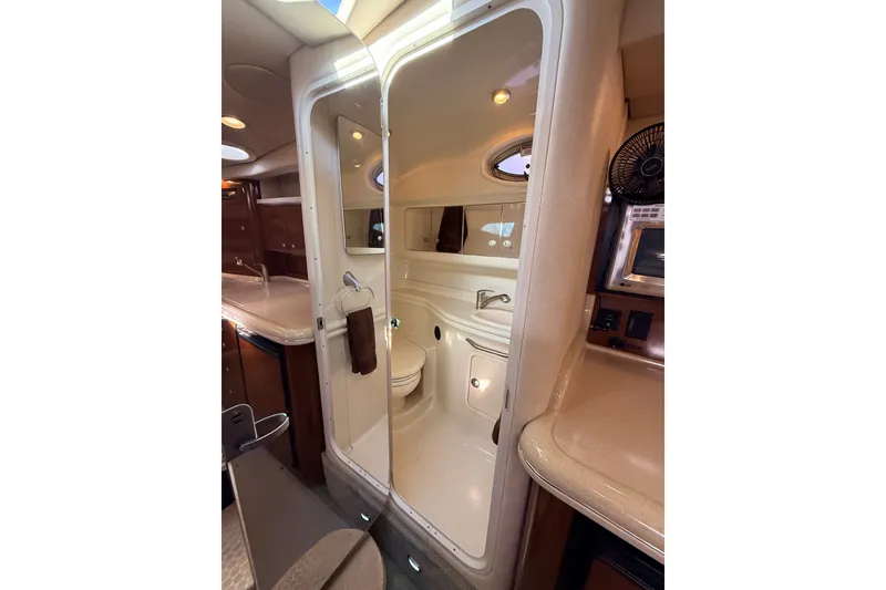 Slide: The Image of Interior of 2008 Sea Ray 340 Sundancer yacht, featuring a compact bathroom and kitchenette. - 35