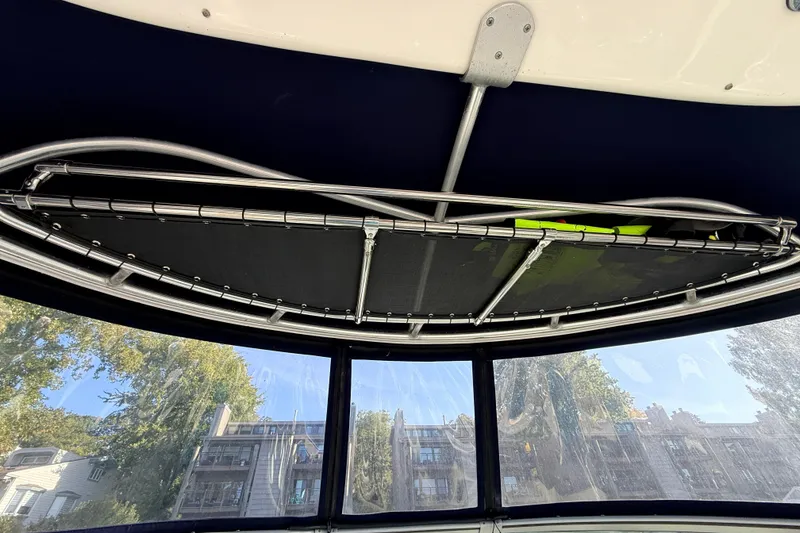 Slide: The Image of Interior view of a 2008 Sea Ray 340 Sundancer boat with a metal frame and windows. - 13