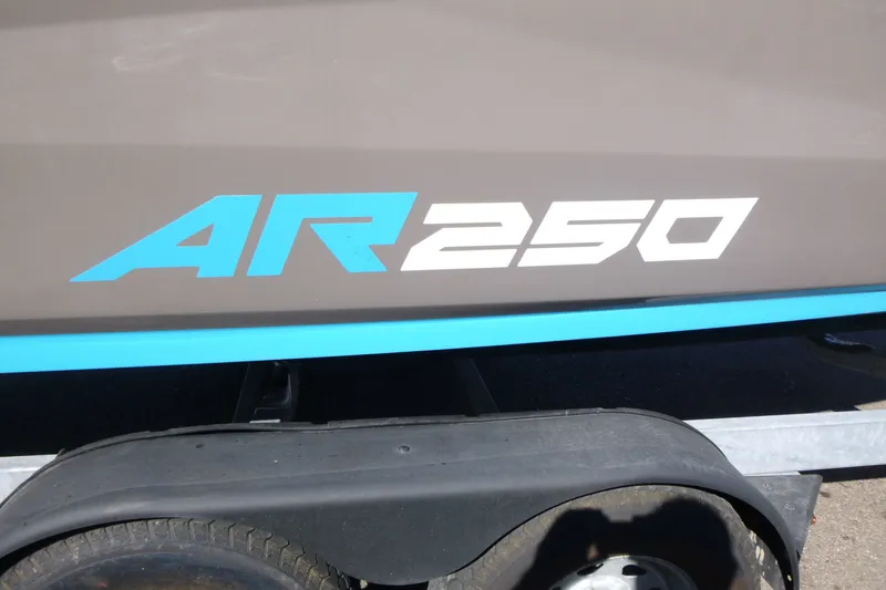Slide: The Image of 2022 Yamaha Boats AR250 logo on boat hull above trailer wheel. - 17
