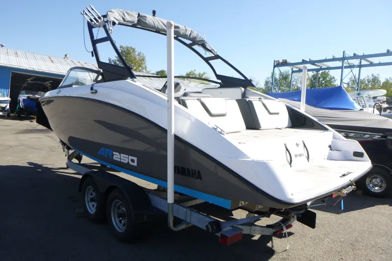 Slide: The Image of 2022 Yamaha Boats AR250 on trailer, displayed outdoors under clear sky. - 4