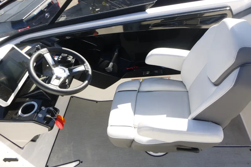 Slide: The Image of 2022 Yamaha Boats AR250 cockpit with steering wheel and comfortable captain's chair. - 9