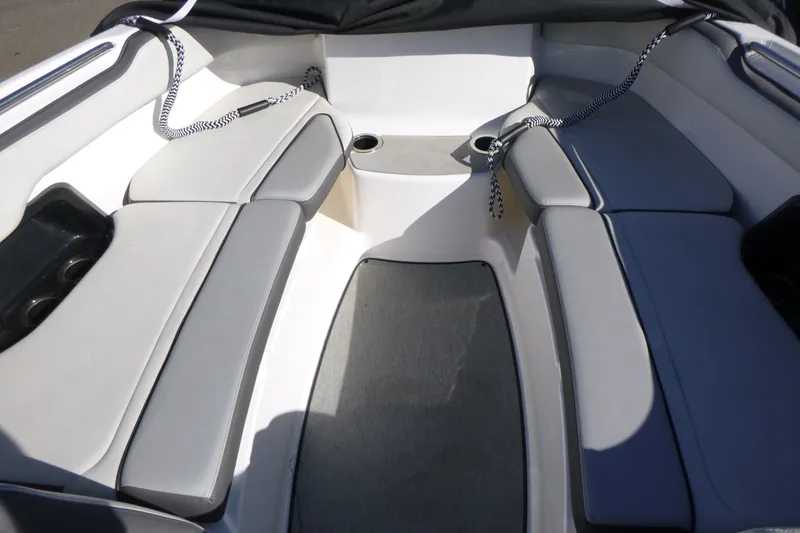Slide: The Image of 2022 Yamaha Boats AR250 interior with cushioned seating and cup holders. - 6
