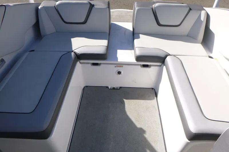 Slide: The Image of 2022 Yamaha Boats AR250 interior seating with gray upholstery and spacious layout. - 14