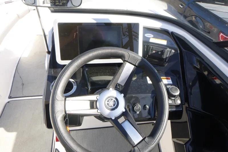 Slide: The Image of Steering wheel and dashboard of 2022 Yamaha Boats AR250, featuring modern controls and display. - 10