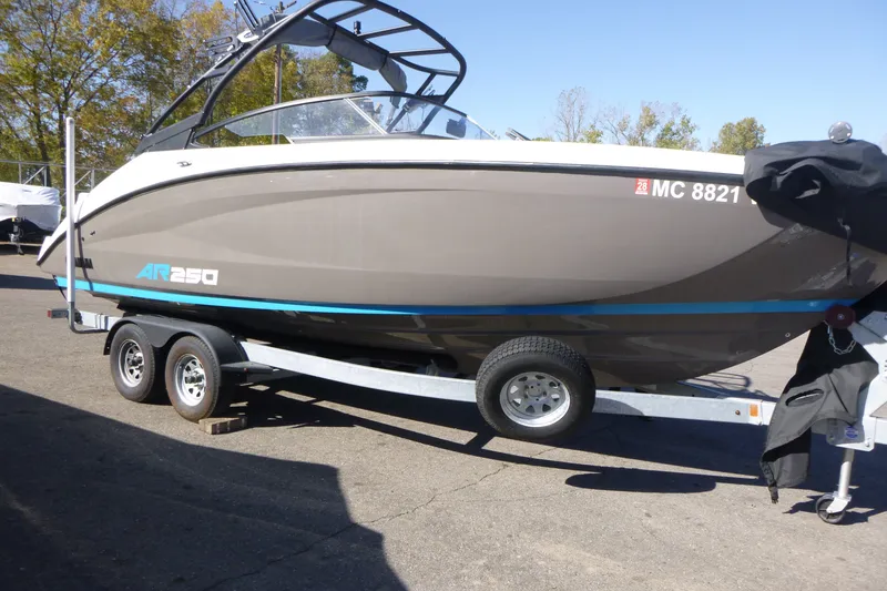 Slide: The Image of 2022 Yamaha Boats AR250 on trailer, parked outdoors, side view. - 1
