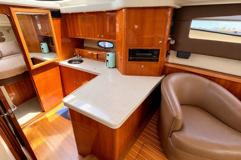 Slide: The Image of Luxurious interior of 2009 Regal 4080 Sportyacht with wood cabinetry and modern amenities. - 7