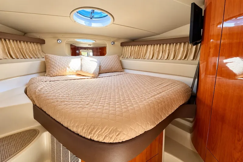 Slide: The Image of Luxurious cabin interior of 2009 Regal 4080 Sportyacht with plush bedding and elegant wood finishes. - 8