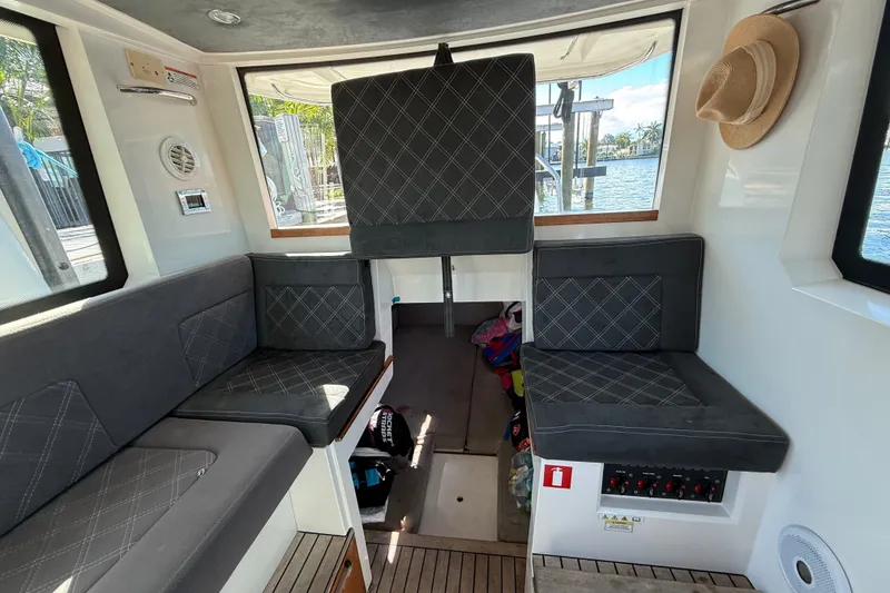 Slide: The Image of Interior of 2018 Axopar 37 Sports Cabin with seating and nautical decor. - 19