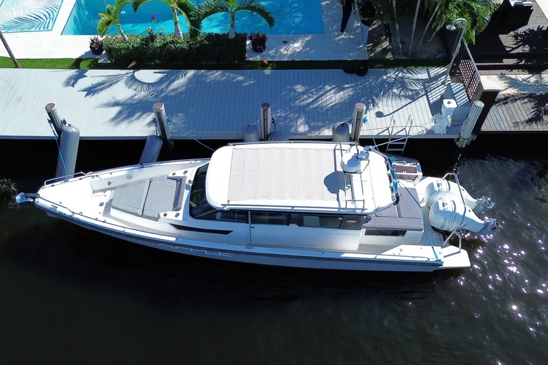 Slide: The Image of Overhead view of 2018 Axopar 37 Sports Cabin docked by a poolside. - 4