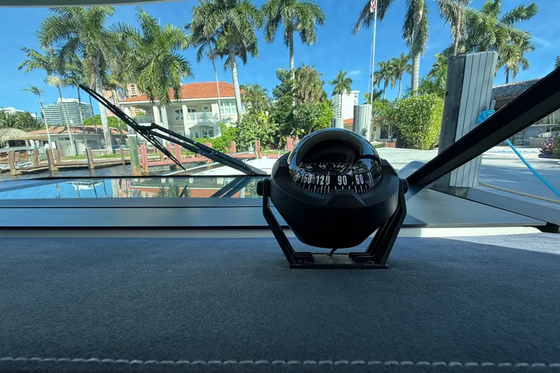 Slide: The Image of Compass view from 2018 Axopar 37 Sports Cabin, overlooking marina with palm trees. - 22