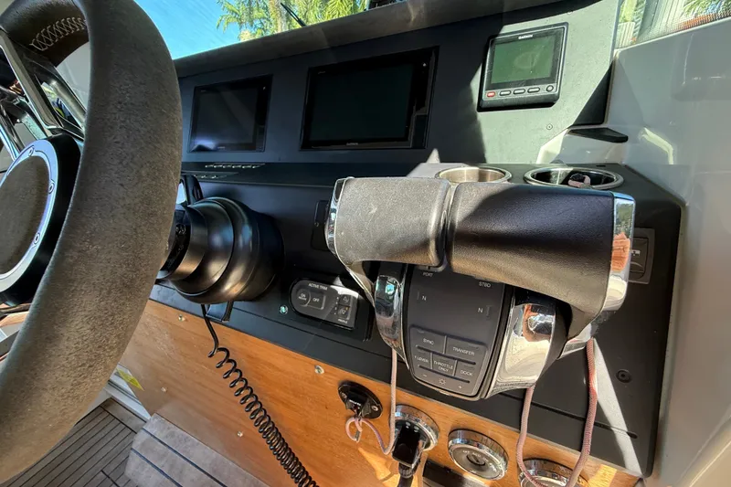 Slide: The Image of Control panel of a 2018 Axopar 37 Sports Cabin boat with steering wheel and throttle. - 14