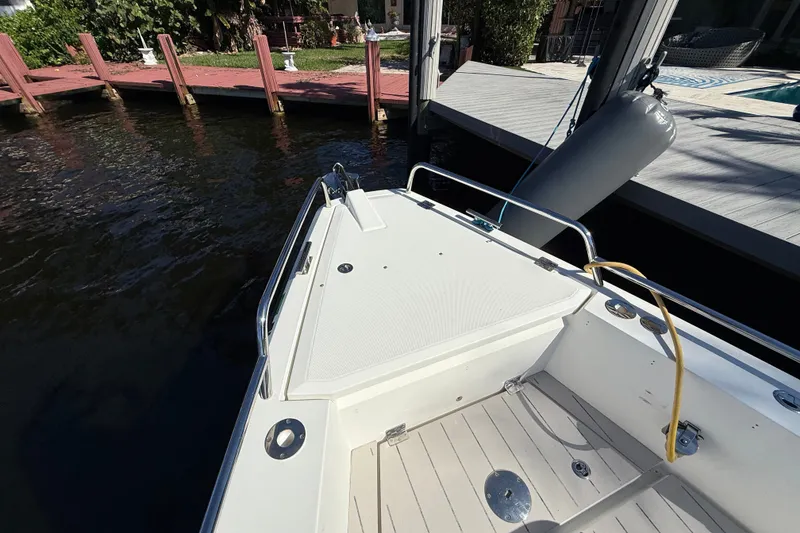 Slide: The Image of Bow of 2018 Axopar 37 Sports Cabin docked by wooden pier. - 30