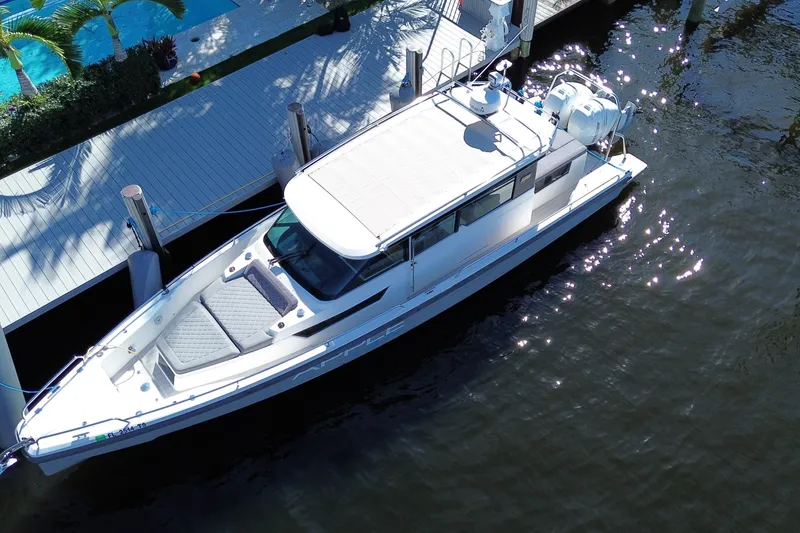 Slide: The Image of Aerial view of 2018 Axopar 37 Sports Cabin docked by a waterfront deck. - 3