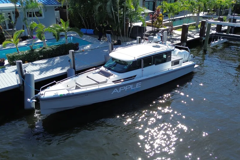 Slide: The Image of 2018 Axopar 37 Sports Cabin docked by a luxurious waterfront property. - 1