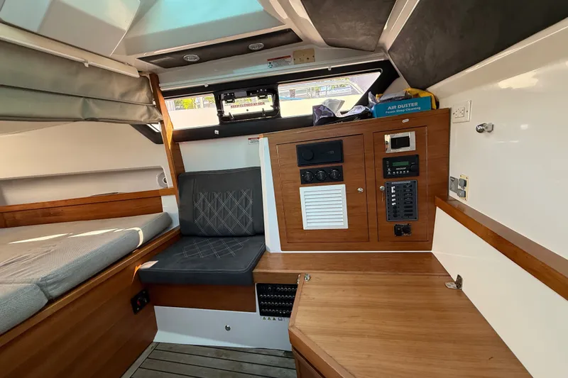 Slide: The Image of 2018 Axopar 37 Sports Cabin interior with seating and control panel. - 24