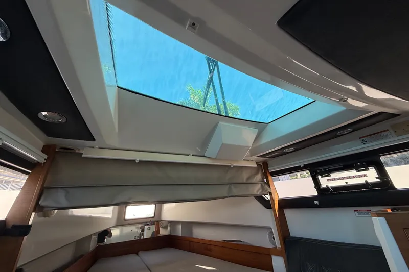 Slide: The Image of Interior view of 2018 Axopar 37 Sports Cabin with skylight and modern design. - 27