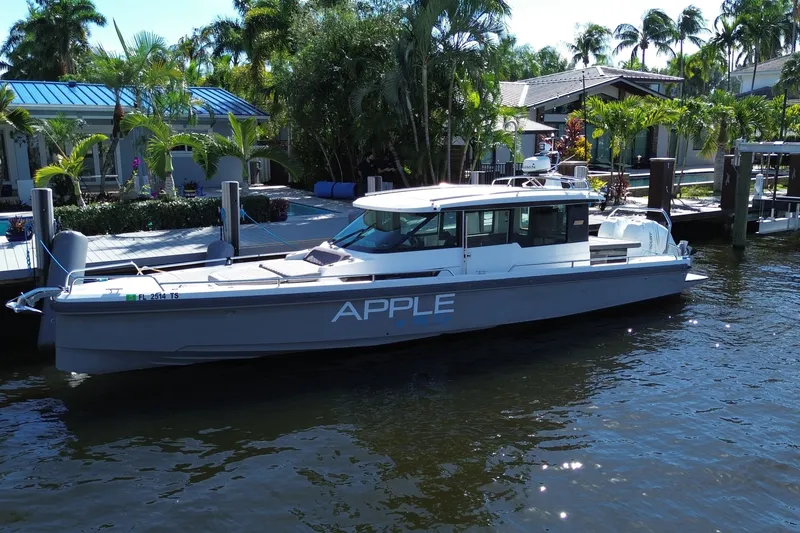 The Image of 2018 Axopar 37 Sports Cabin boat docked by a tropical waterfront home. - 0