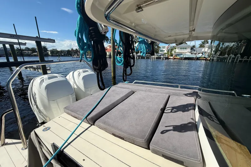 Slide: The Image of 2018 Axopar 37 Sports Cabin with twin engines, docked by waterfront homes. - 8