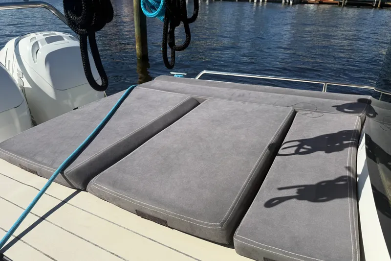 Slide: The Image of 2018 Axopar 37 Sports Cabin with cushioned deck, docked by the water. - 7