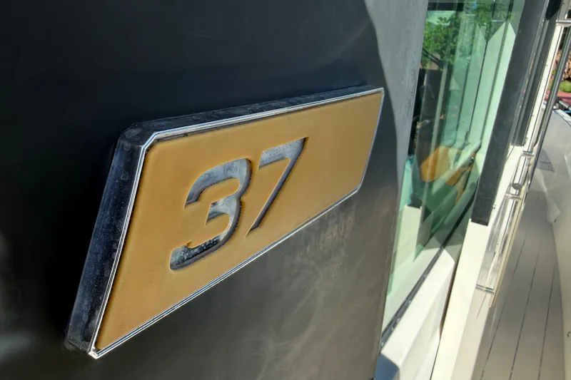 Slide: The Image of Close-up of 2018 Axopar 37 Sports Cabin emblem on boat exterior. - 33