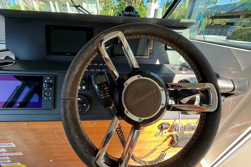 Slide: The Image of Steering wheel and dashboard of 2018 Axopar 37 Sports Cabin boat. - 13