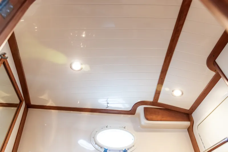 Slide: The Image of Interior ceiling of 2013 Hinckley Talaria 34 yacht with wood trim and recessed lighting. - 34