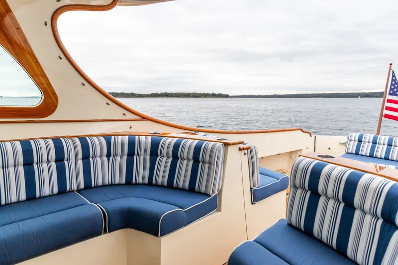 Slide: The Image of Luxurious 2013 Hinckley Talaria 34 yacht interior with striped seating and scenic water view. - 18