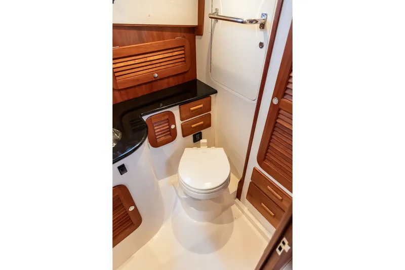 Slide: The Image of Luxurious 2013 Hinckley Talaria 34 yacht bathroom with wooden cabinetry and modern fixtures. - 32