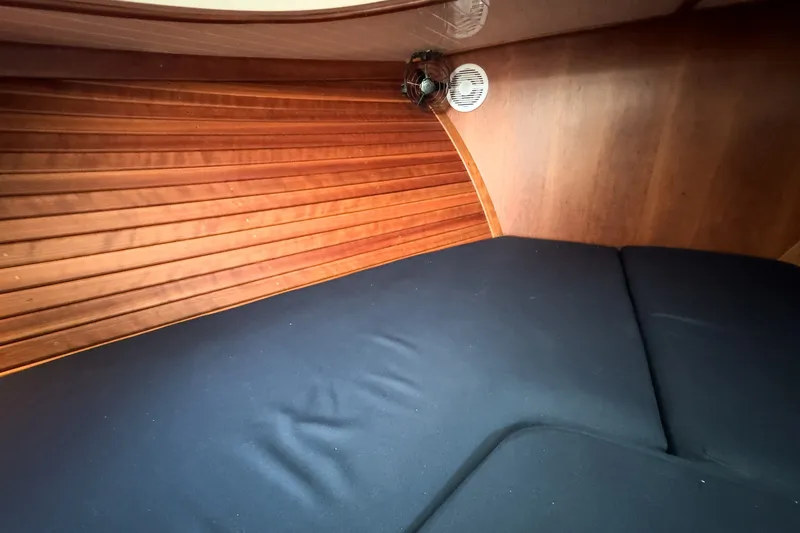 Slide: The Image of Interior cabin of 2013 Hinckley Talaria 34 with wooden paneling and cushioned seating. - 37