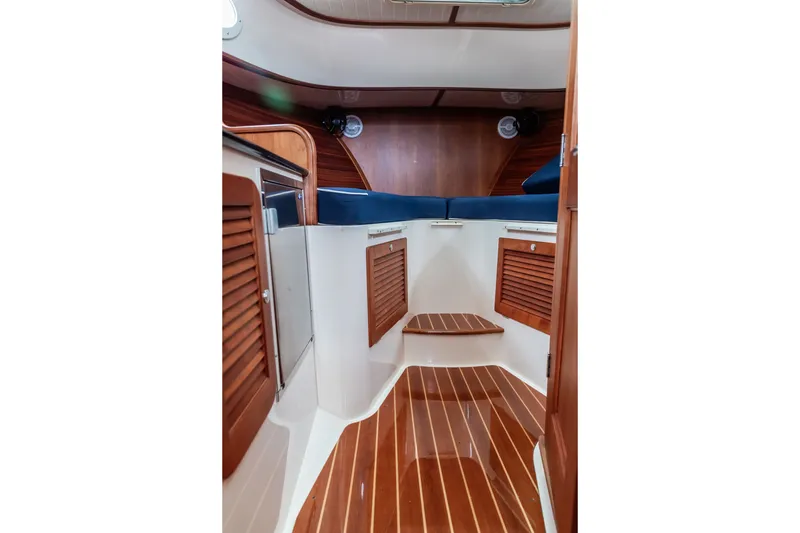 Slide: The Image of Interior of 2013 Hinckley Talaria 34 yacht with polished wood and blue seating. - 30