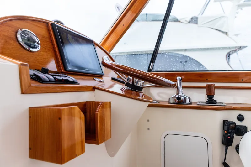 Slide: The Image of Interior helm of 2013 Hinckley Talaria 34 yacht with wooden accents and modern controls. - 22