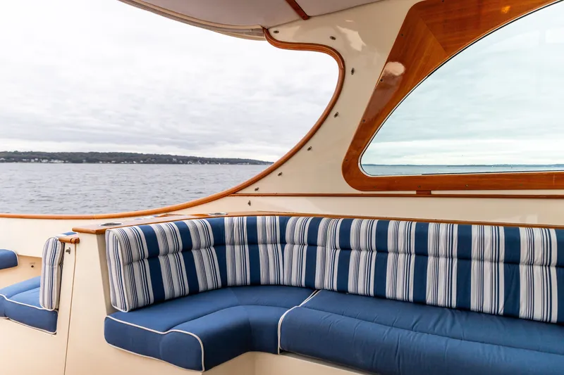 Slide: The Image of Luxurious interior of 2013 Hinckley Talaria 34 yacht with striped seating and scenic ocean view. - 19