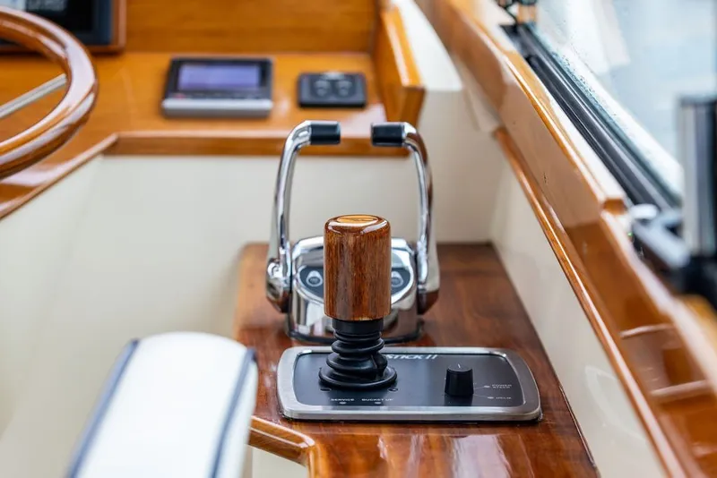 Slide: The Image of Helm controls of a 2013 Hinckley Talaria 34 yacht with wooden accents. - 25