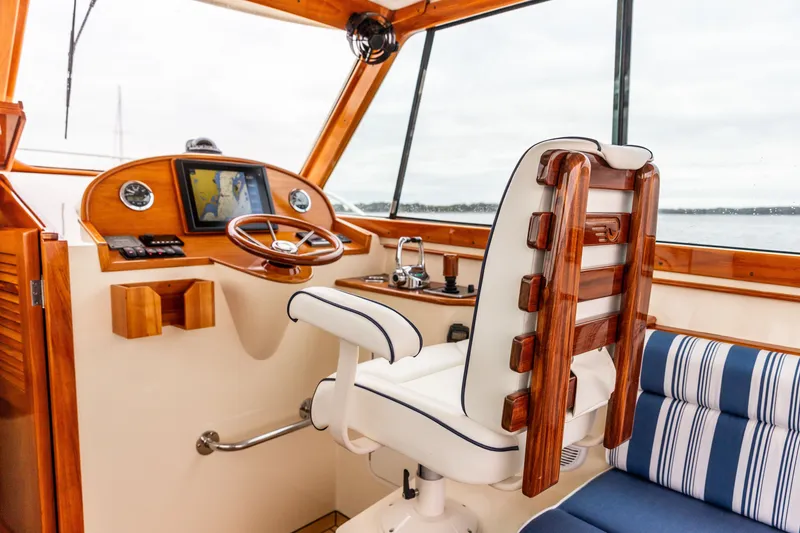 Slide: The Image of Interior of 2013 Hinckley Talaria 34 yacht with wooden helm and plush seating. - 20