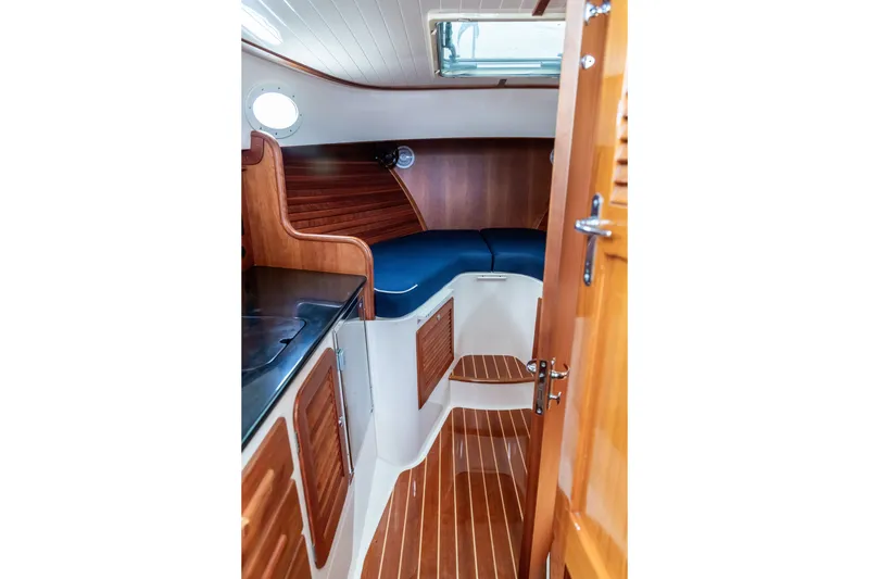 Slide: The Image of Interior of 2013 Hinckley Talaria 34 yacht with wooden cabinetry and blue seating. - 29