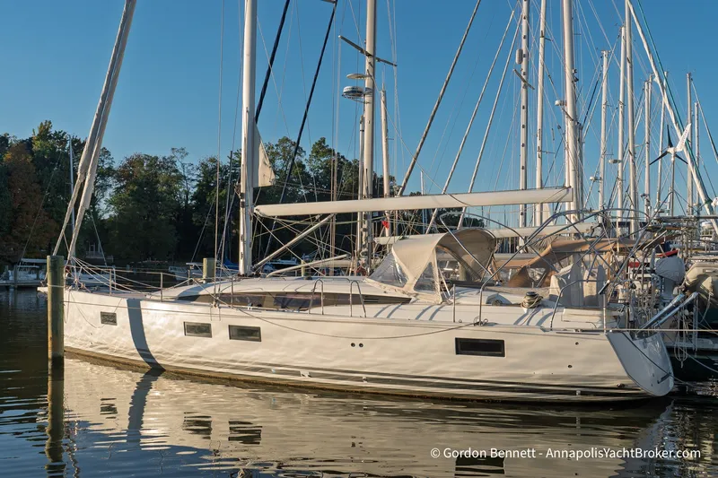 The Image of 2020 Jeanneau 51 yacht docked in a serene marina setting. - 0