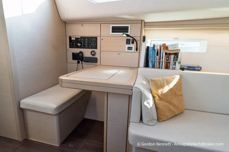 Slide: The Image of Interior of a 2020 Jeanneau 51 yacht with navigation station and cozy seating area. - 24