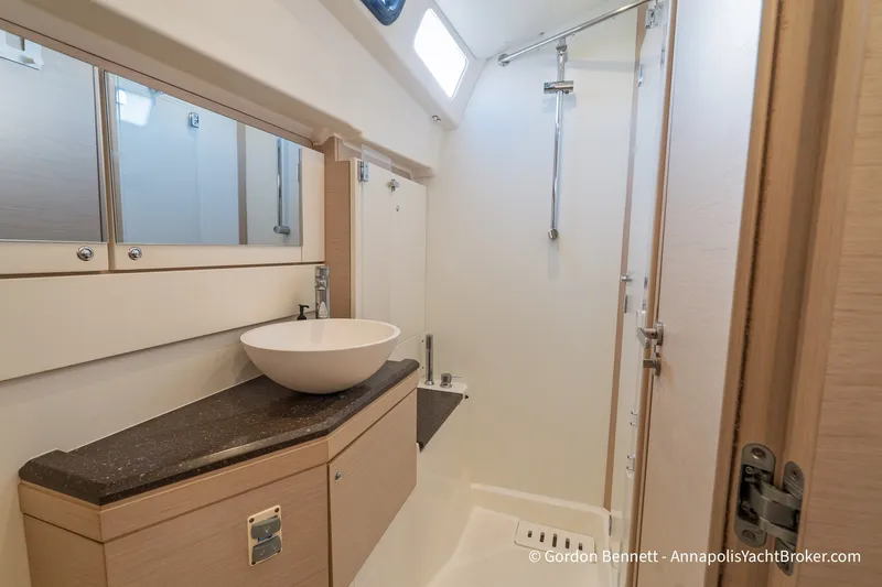 Slide: The Image of Modern bathroom interior on a 2020 Jeanneau 51 yacht, featuring a sleek basin and shower. - 35