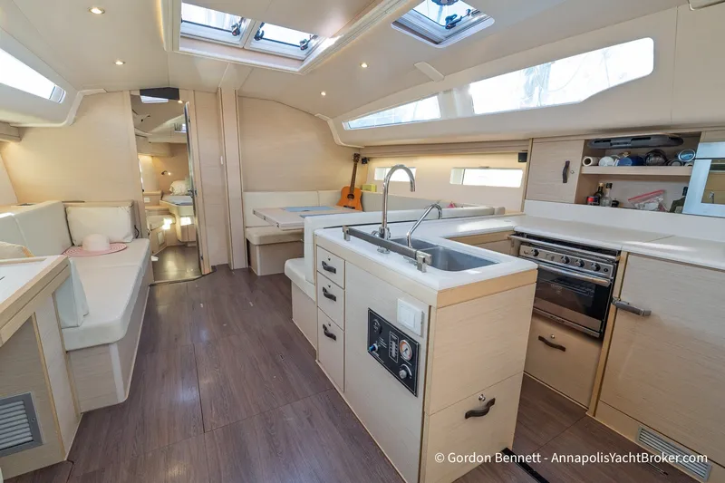Slide: The Image of Interior of 2020 Jeanneau 51 yacht with modern kitchen and seating area. - 21
