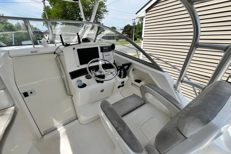 Slide: The Image of 2006 Boston Whaler 285 Conquest helm with steering wheel and navigation equipment. - 27