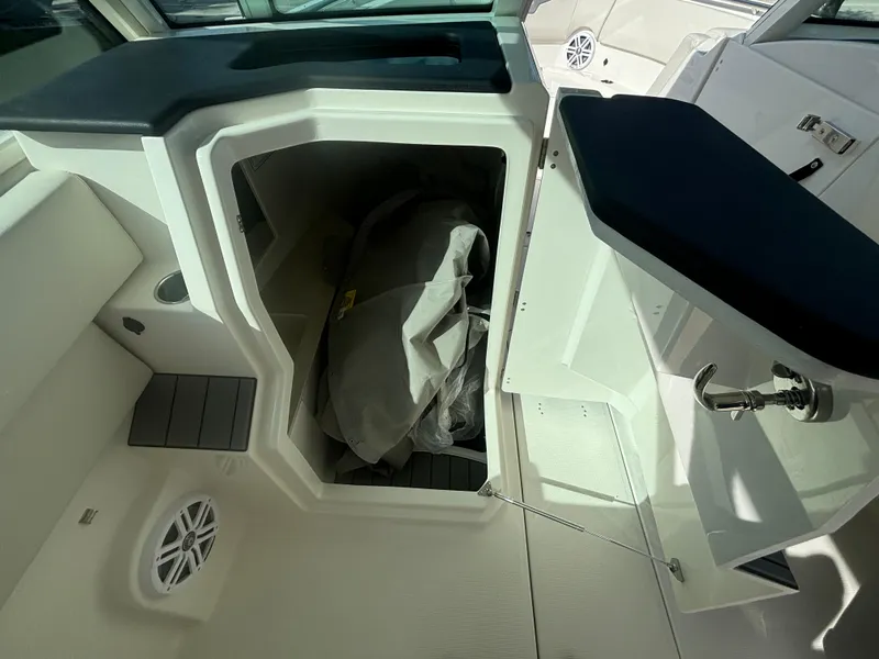 Slide: The Image of 2025 Sailfish 316 DC boat storage compartment with open hatch and visible interior. - 15