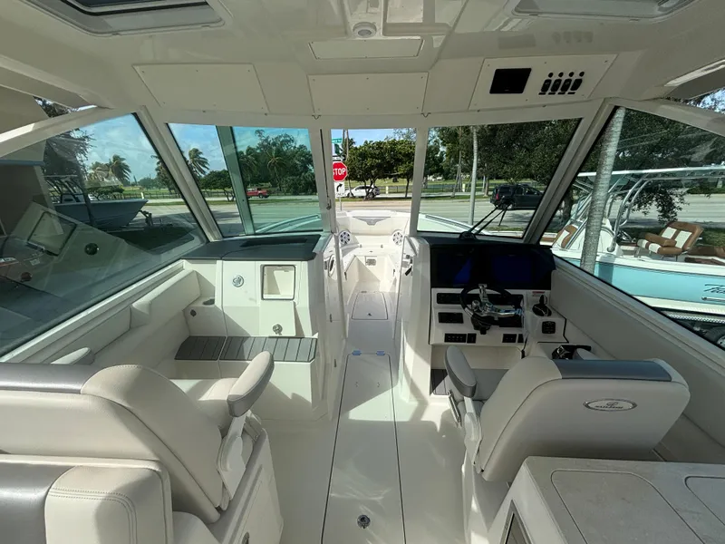 Slide: The Image of Interior of 2025 Sailfish 316 DC boat, featuring modern helm and seating. - 13