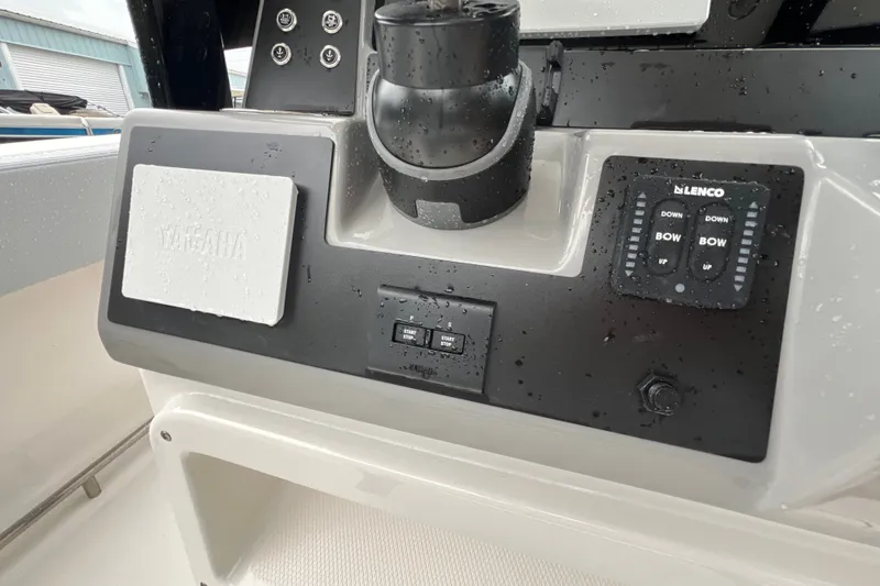 Slide: The Image of 2027 Robalo R250 Center Console dashboard with Yamaha controls and Lenco trim tab switches. - 18