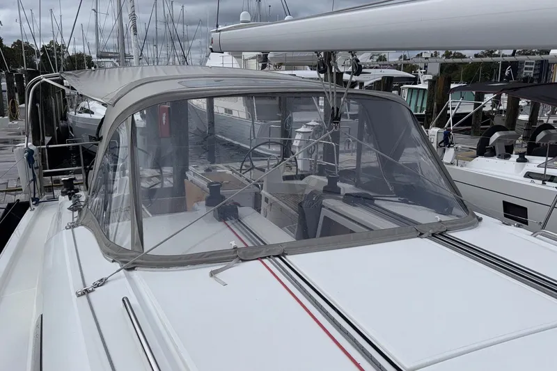 Slide: The Image of 2022 Beneteau Oceanis 40.1 sailboat docked, featuring a covered cockpit and sleek design. - 21