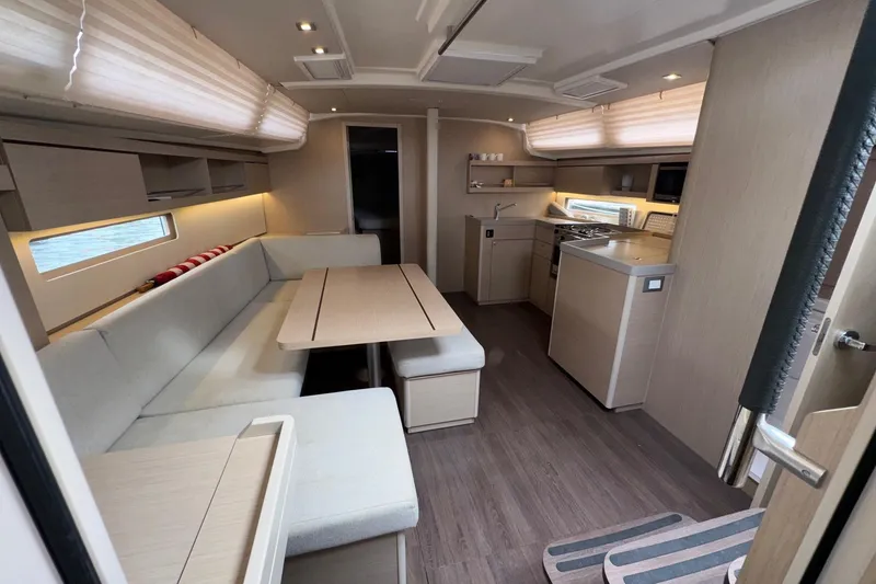 Slide: The Image of Modern interior of 2022 Beneteau Oceanis 40.1 yacht with spacious seating and kitchen area. - 24