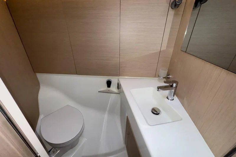 Slide: The Image of Modern bathroom in 2022 Beneteau Oceanis 40.1 yacht, featuring sleek sink and toilet. - 38