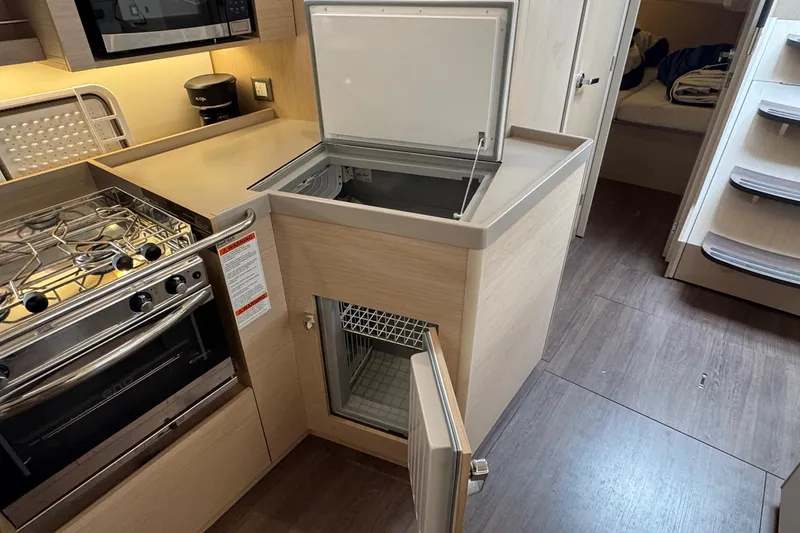 Slide: The Image of Modern kitchen interior of 2022 Beneteau Oceanis 40.1 yacht with stove and fridge. - 30