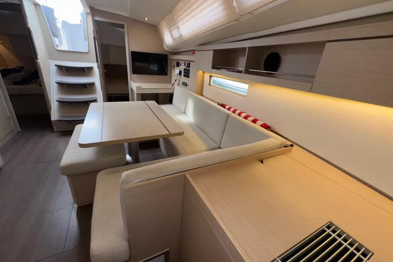Slide: The Image of Interior of 2022 Beneteau Oceanis 40.1 yacht, featuring modern seating and dining area. - 27